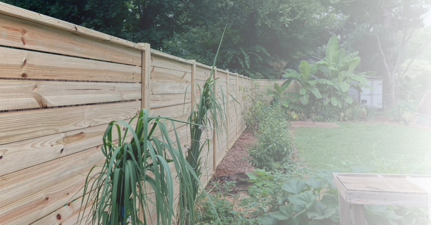 simple wooden fence arounf landscaped lawn